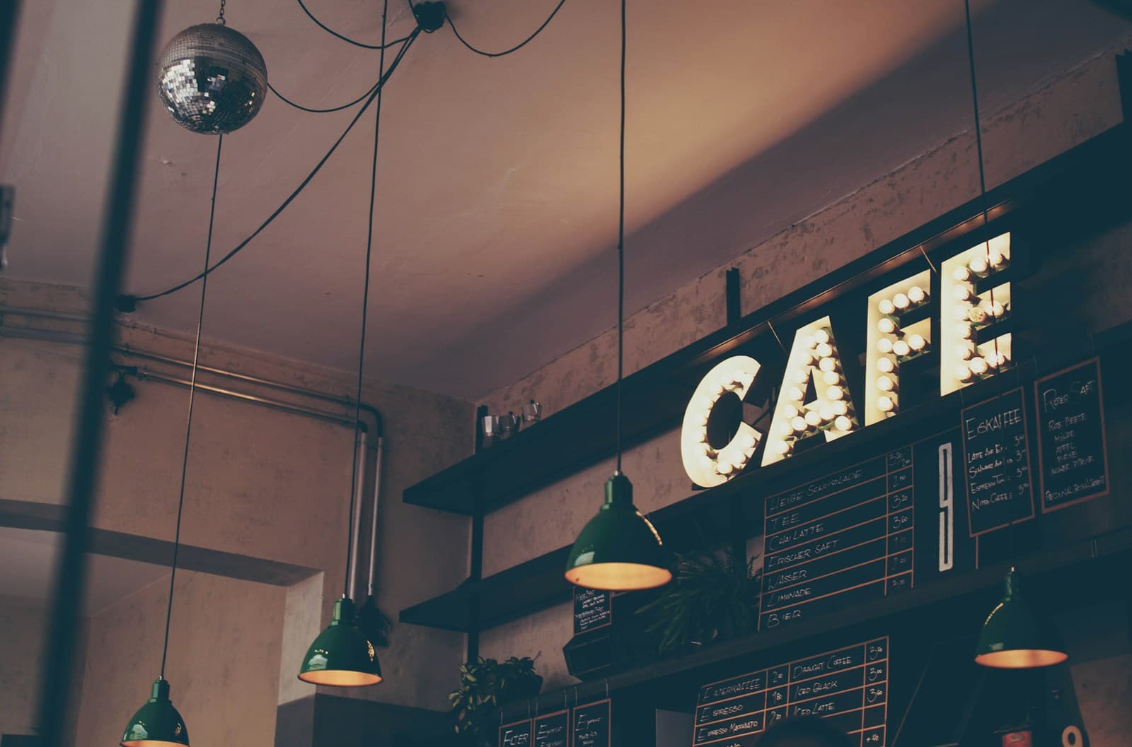 Café counter with pendant lights and a chalkboard menu